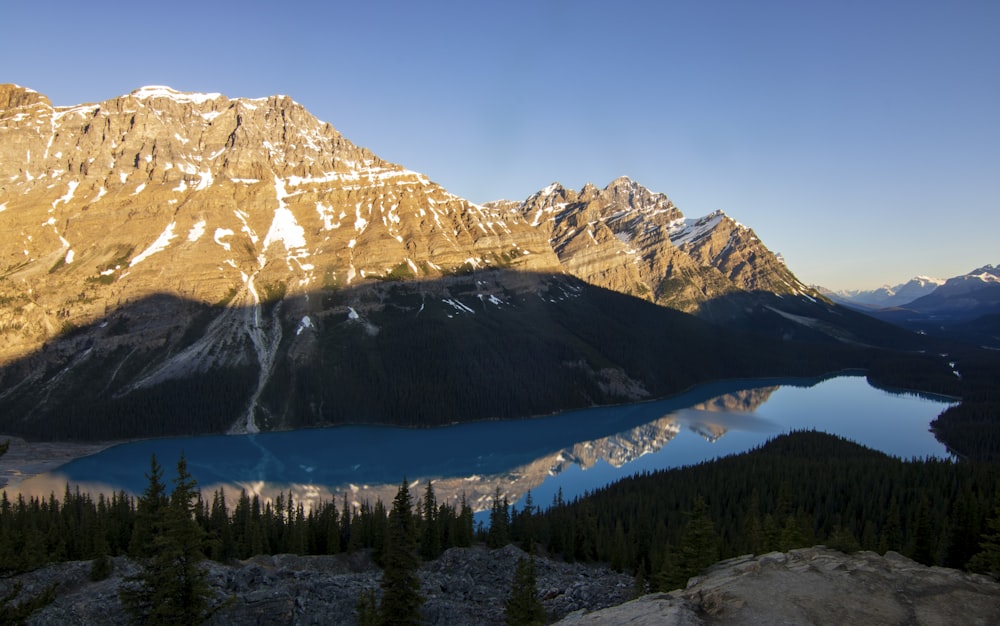 a view of a mountain range with a lake in the foreground