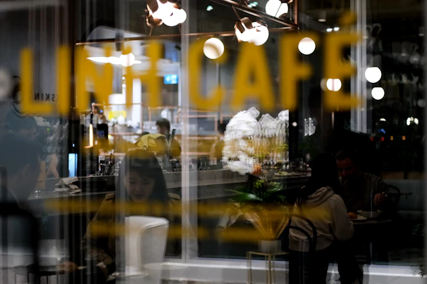 Modern café with customers enjoying coffee while gentle music plays in the background.