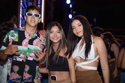 A group of friends dressed in bold, stylish rave outfits enjoying a vibrant nightlife scene.