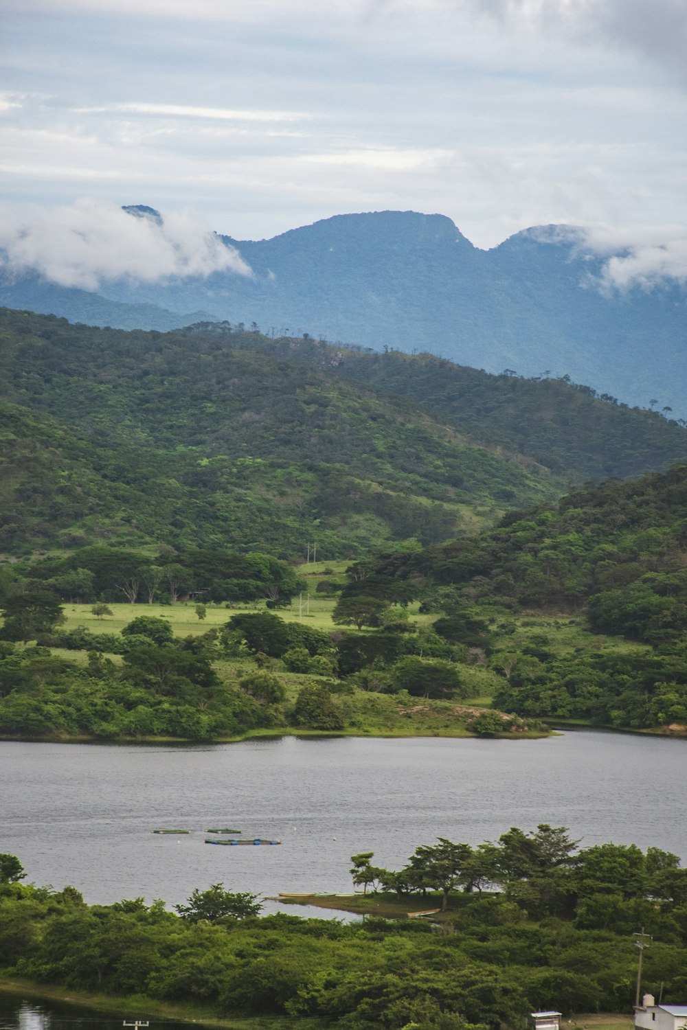 a large body of water surrounded by lush green hills