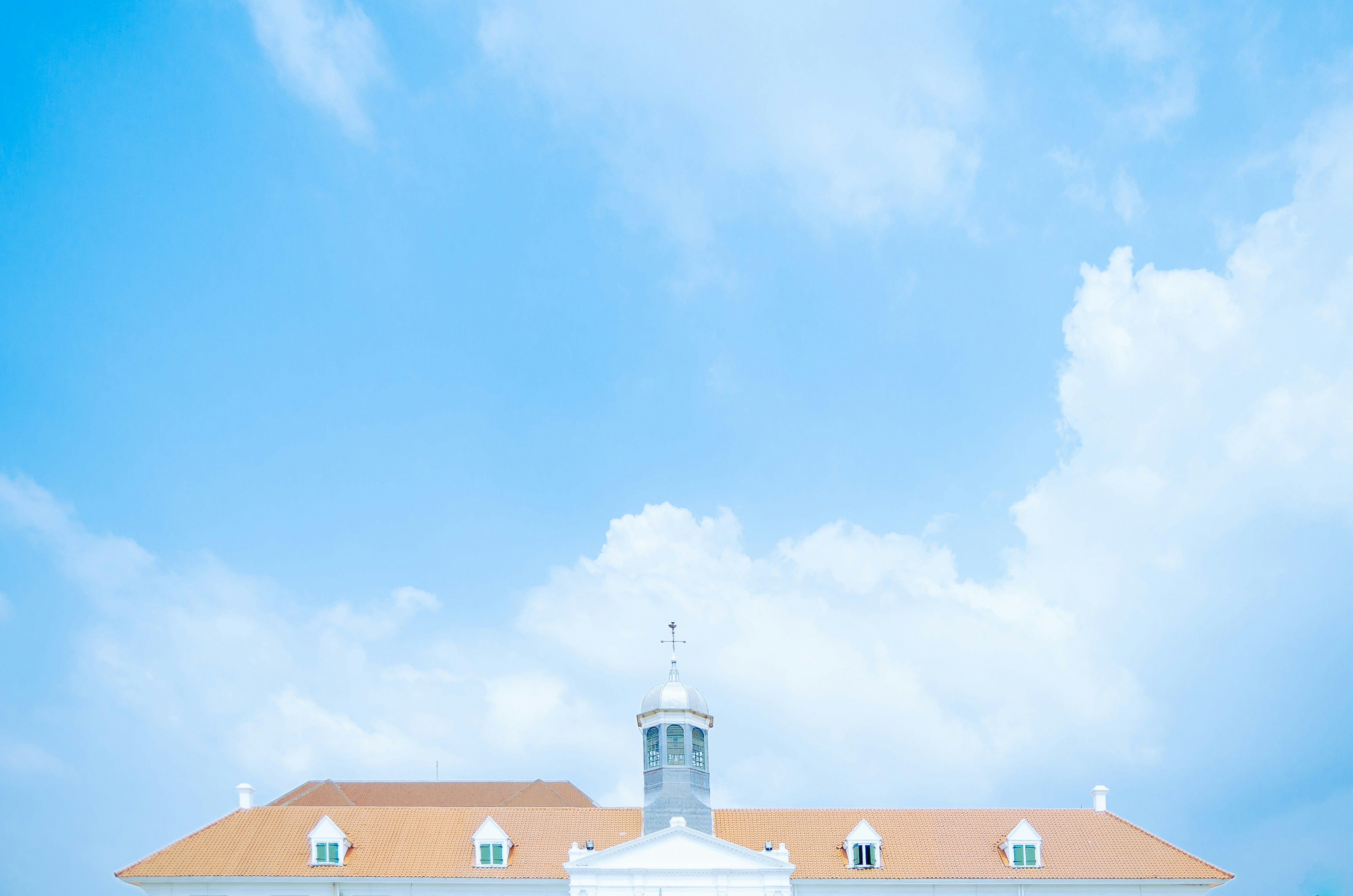 a large white building with a clock tower