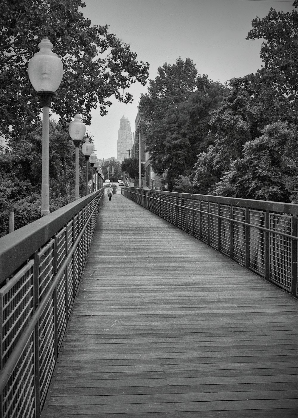 a black and white photo of a wooden bridge