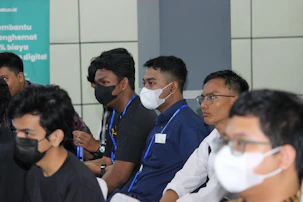 An instructor leading a health and safety training session with attentive participants.