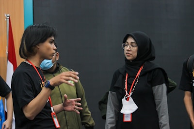 A candid moment of Prof. Hagher engaged in conversation with an audience member after a talk.