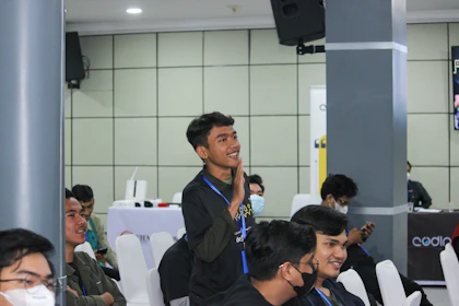 Teenagers presenting their business ideas confidently to a panel of judges.