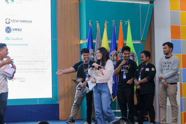 A dynamic group photo of five international speakers sharing ideas on stage at a financial event.