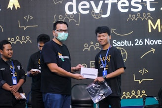 A handshake over a tablet showing digital innovation graphics.