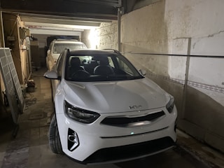 Cozy closed garage space with a car parked inside at a duplex apartment.