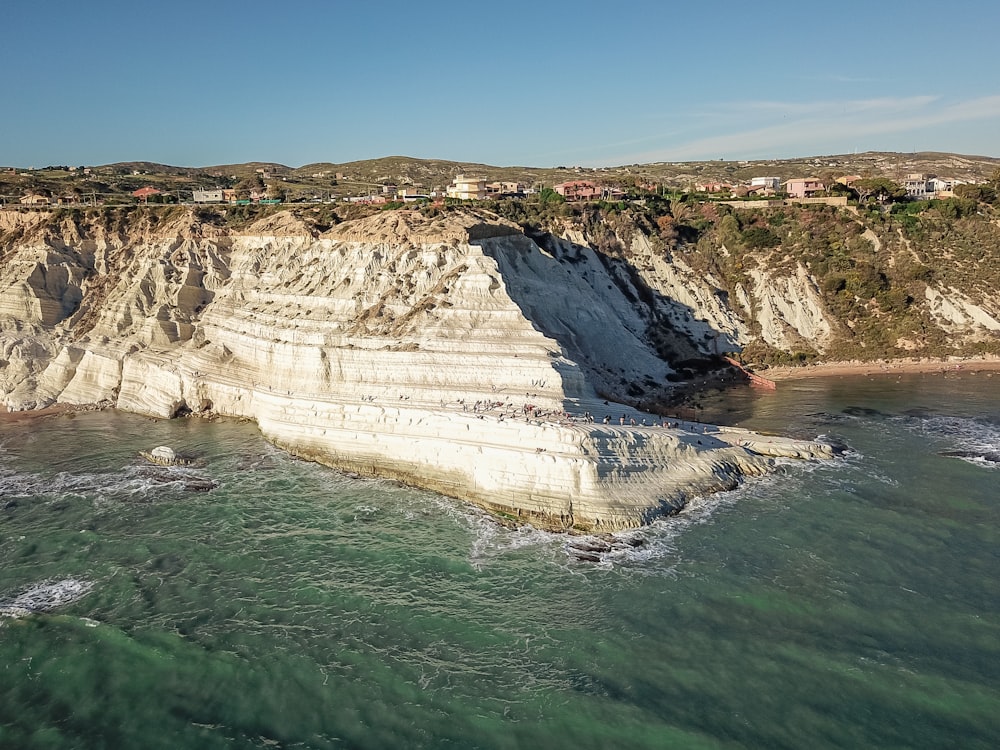 an aerial view of a cliff with houses on top of it