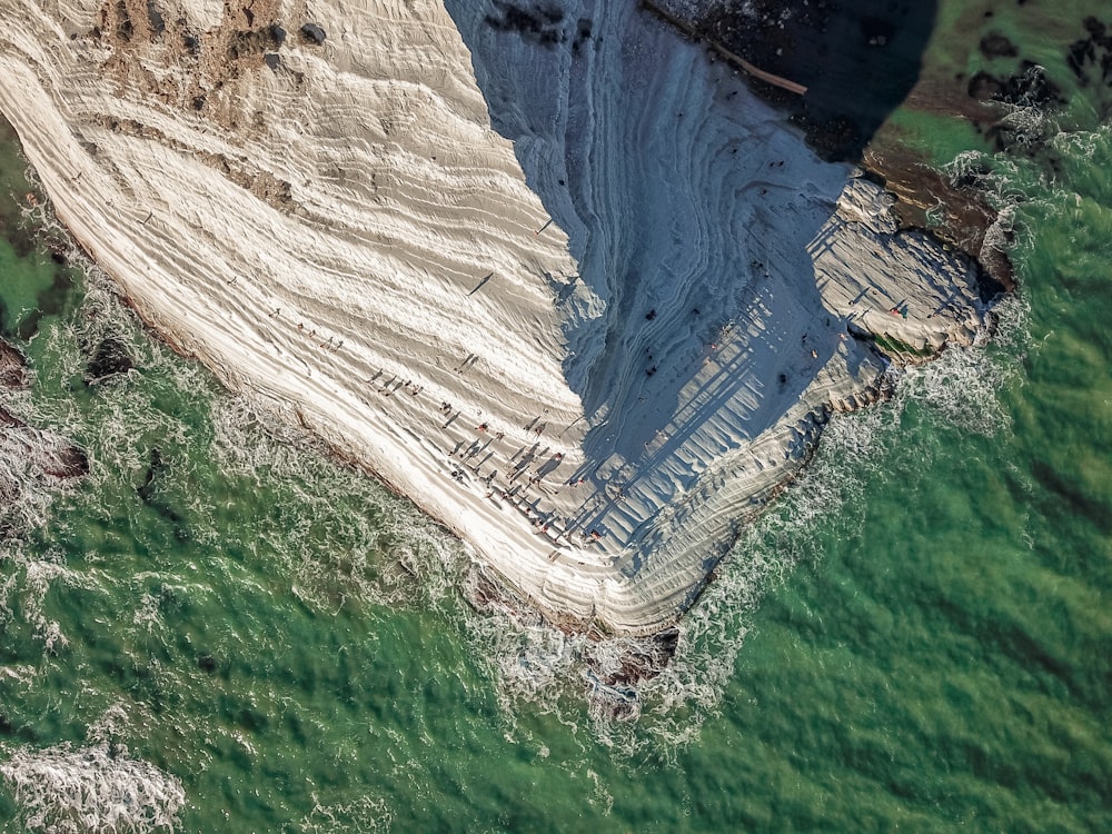 an aerial view of a beach and a cliff