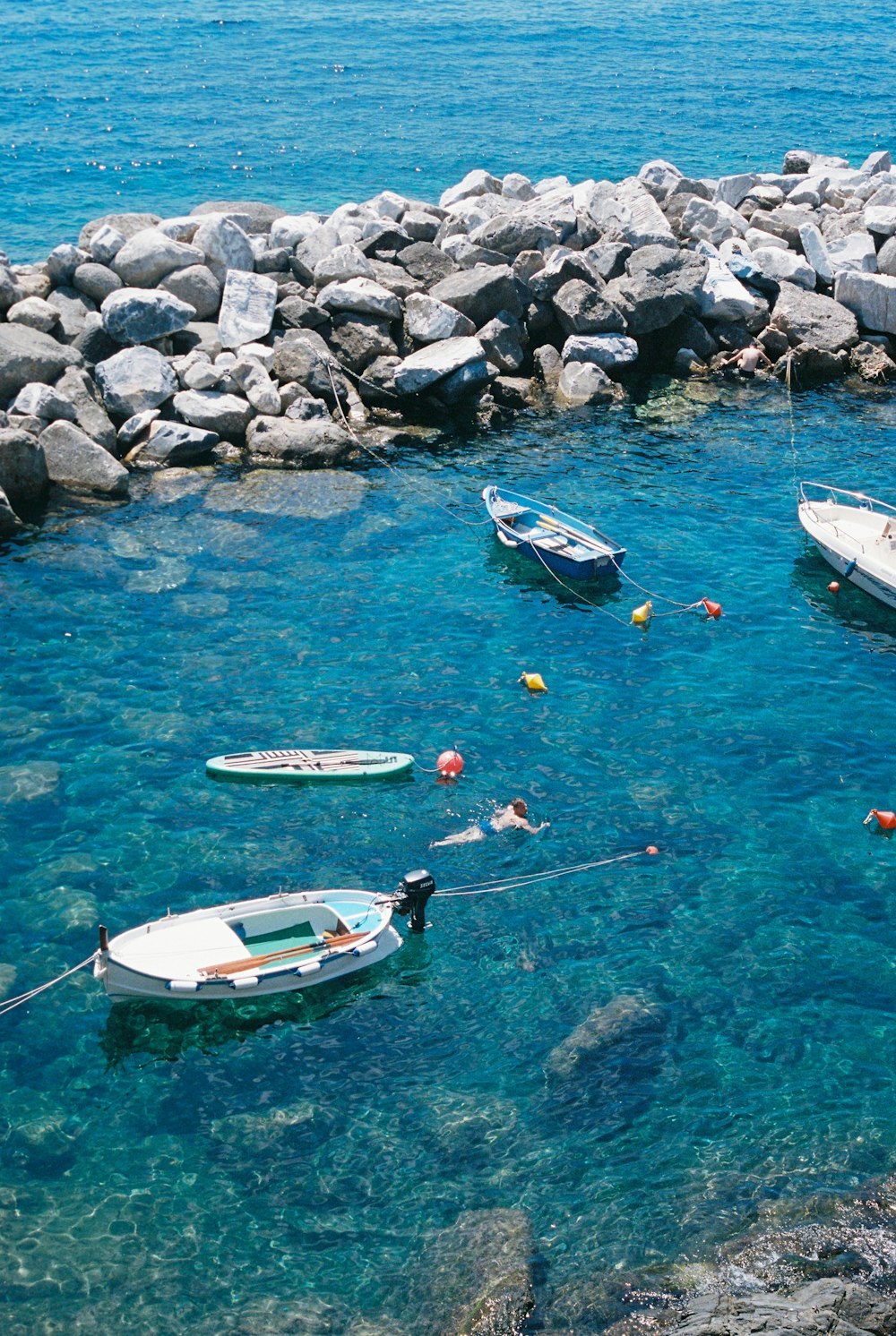 a group of boats floating on top of a body of water