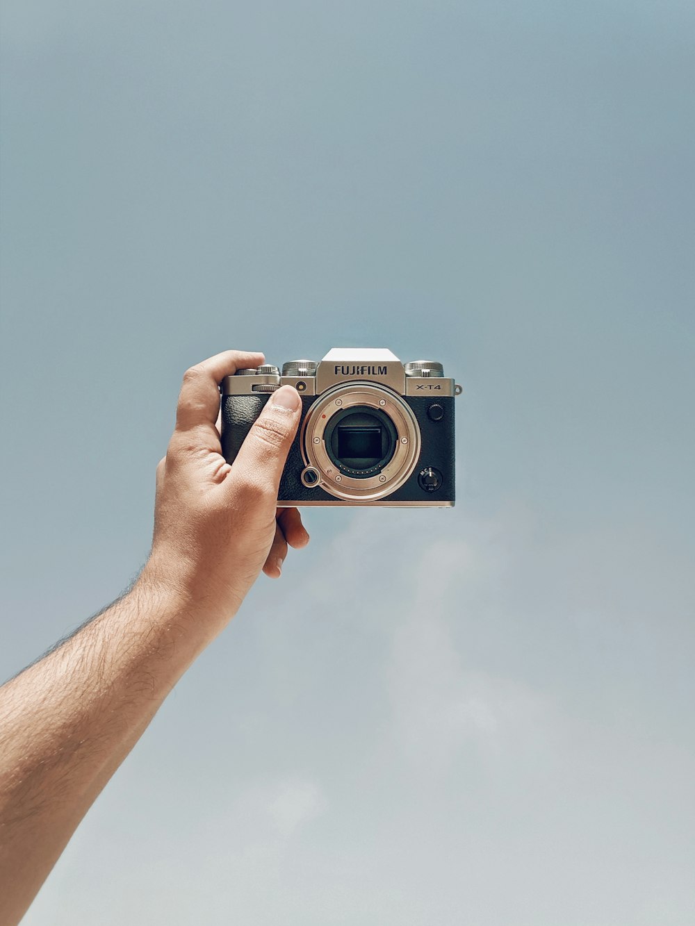 a person holding a camera up in the air