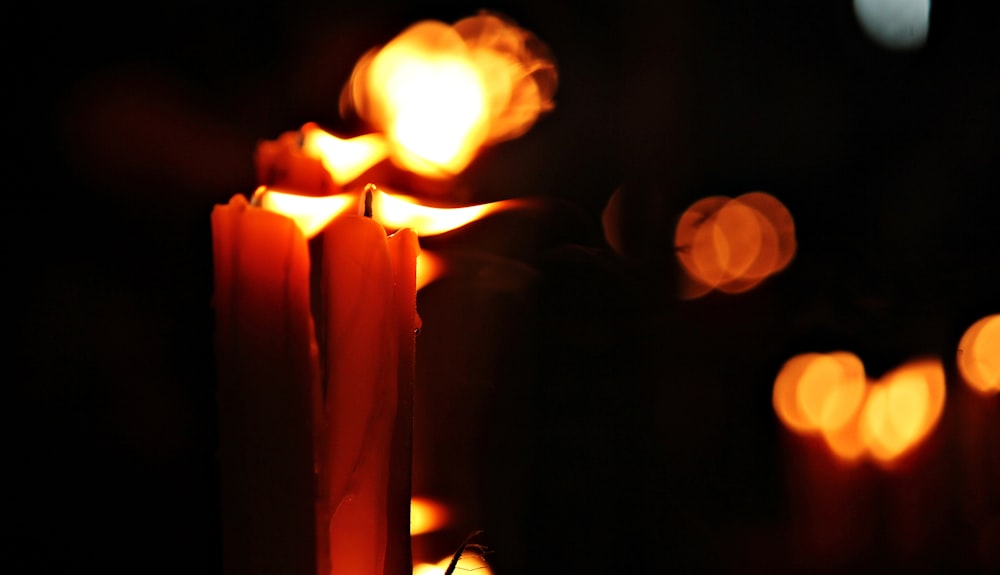a close up of a lit candle in the dark