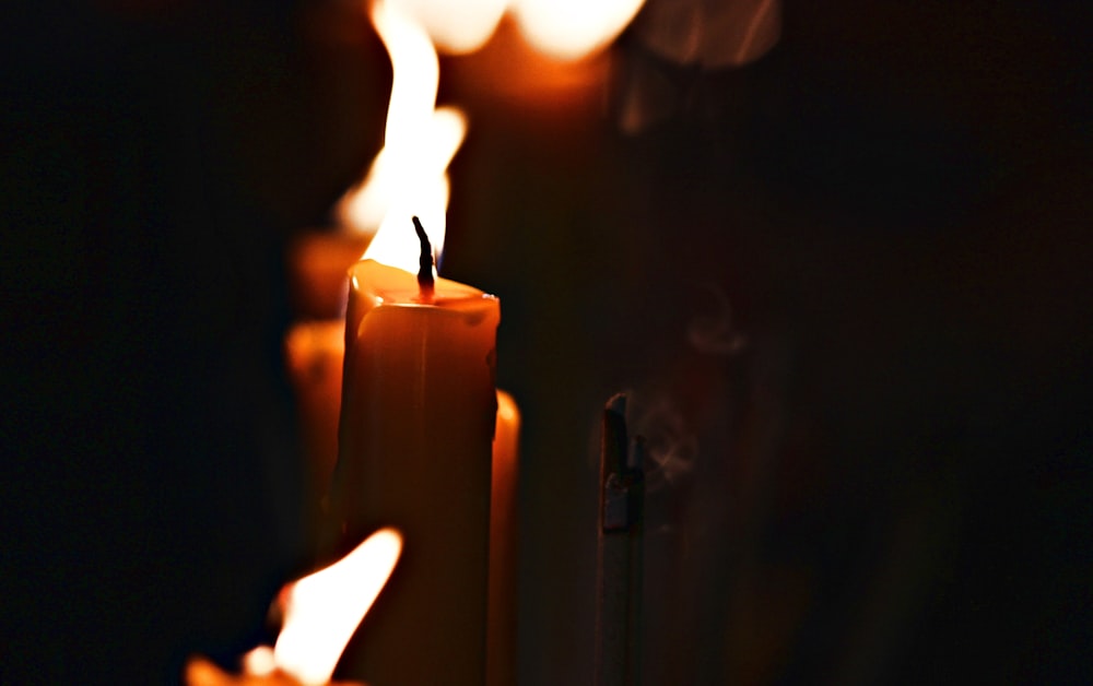 a row of lit candles sitting next to each other