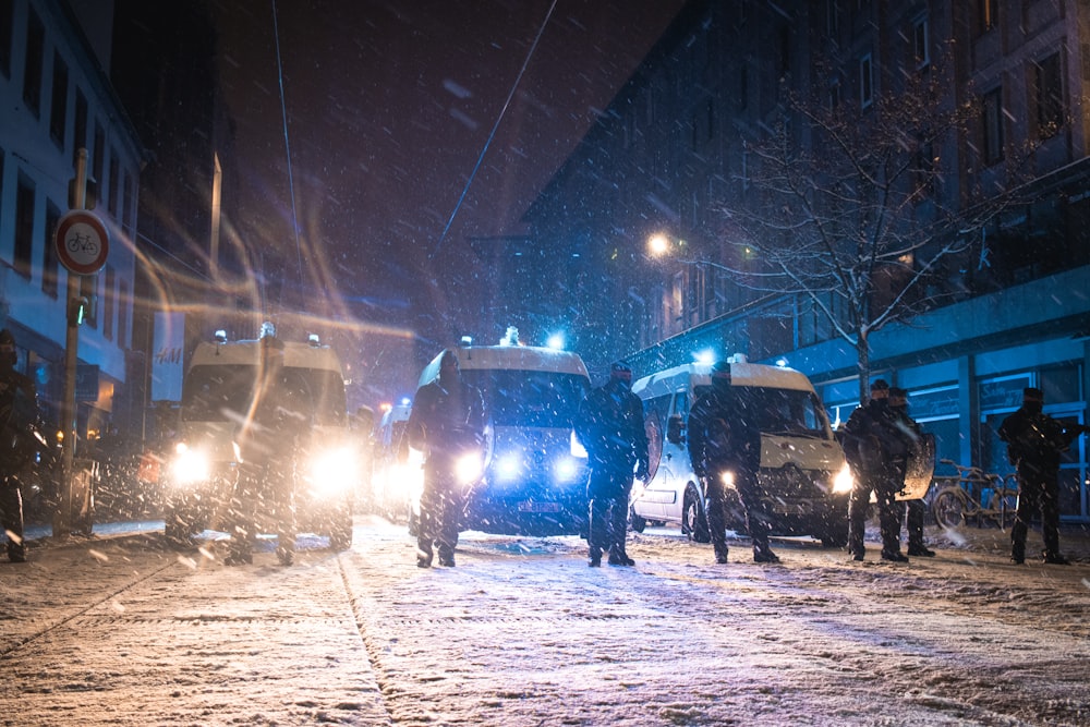 a group of people standing on a snow covered street