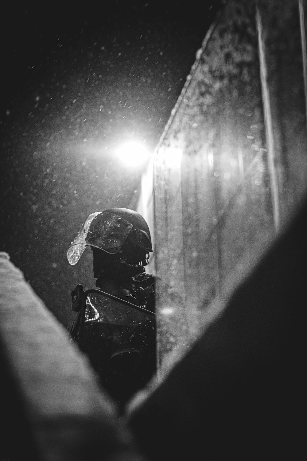 a black and white photo of a person wearing a helmet