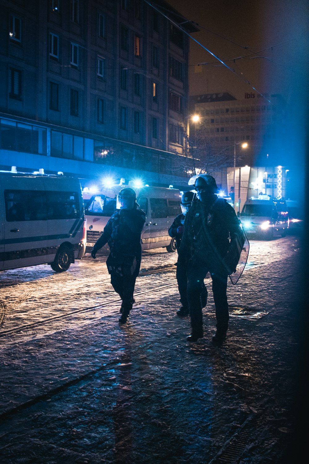 deux policiers marchant dans une rue la nuit