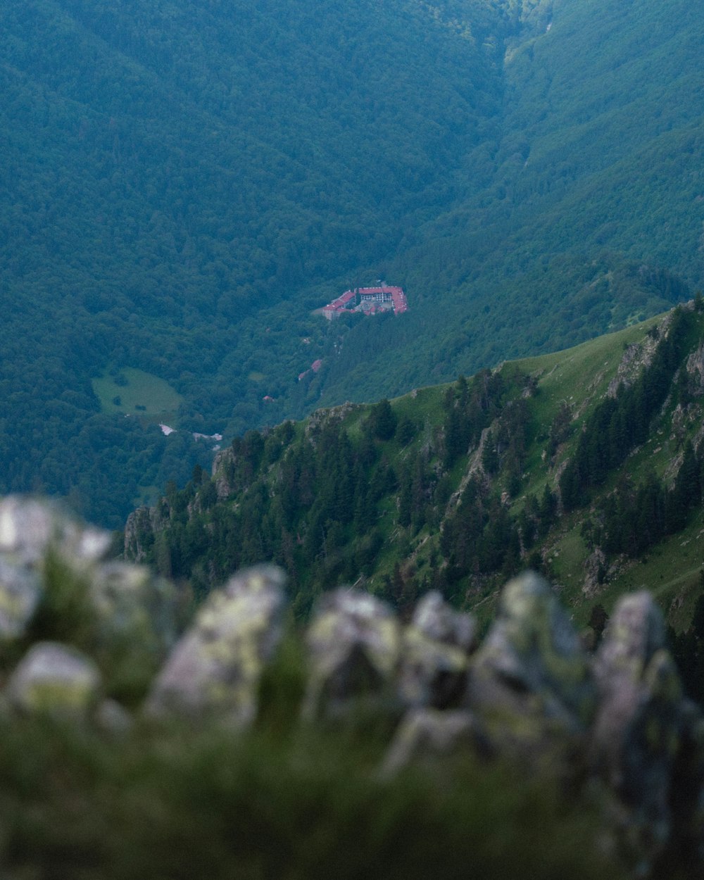 a view of a mountain with a house in the distance