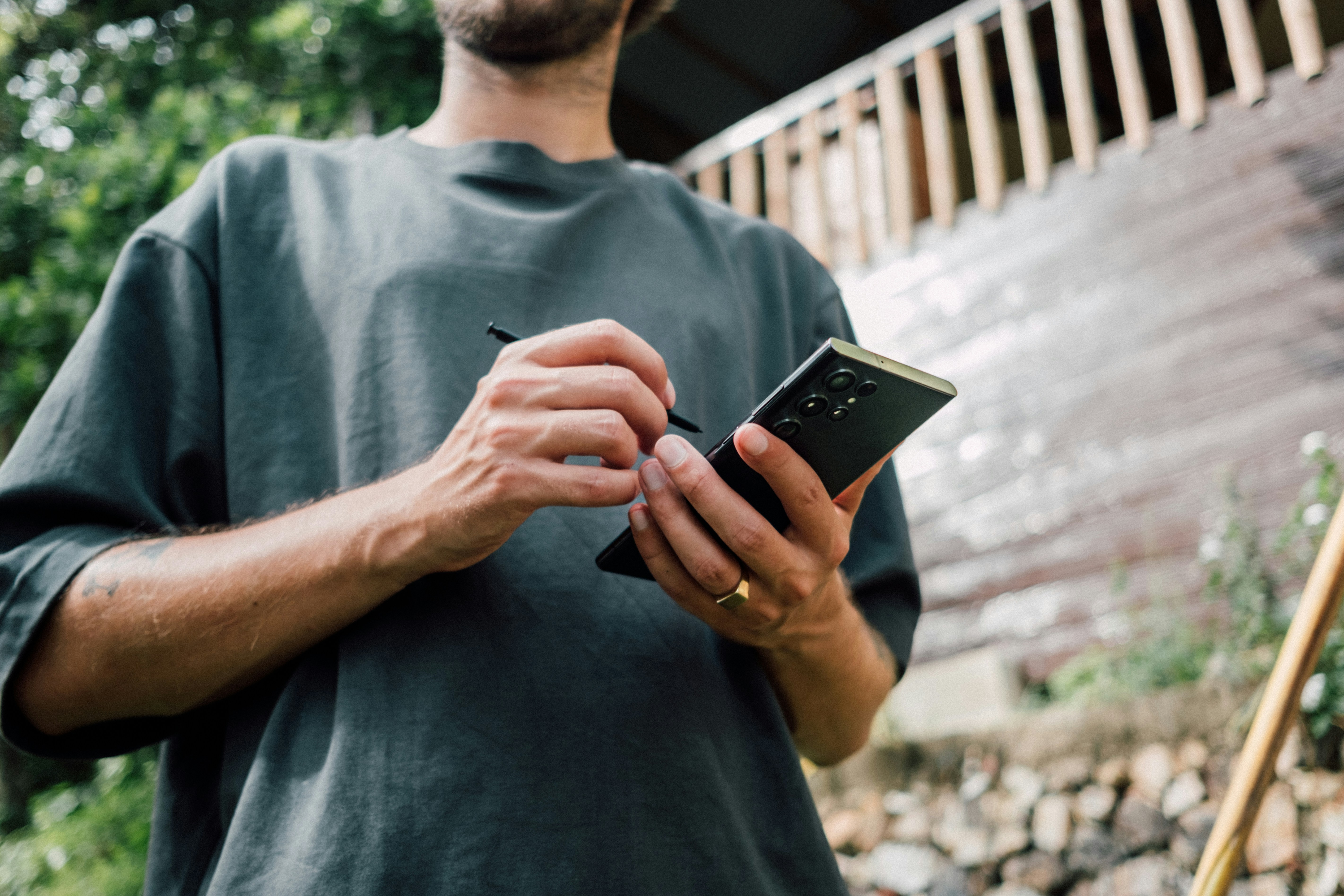 a man holding a cell phone in his hands, Young man holding Samsung