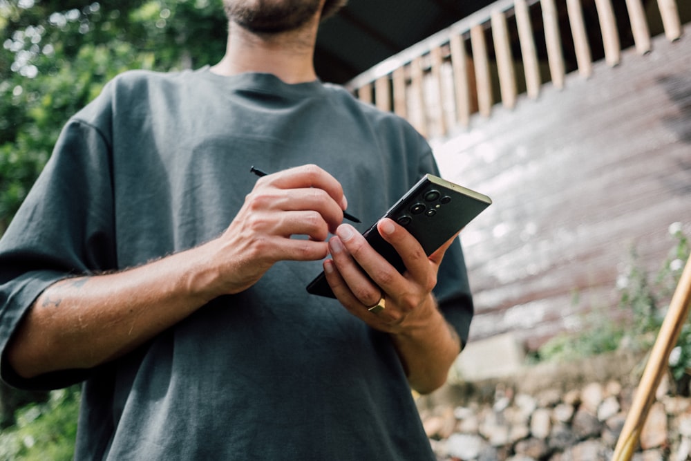 a man holding a cell phone in his hands