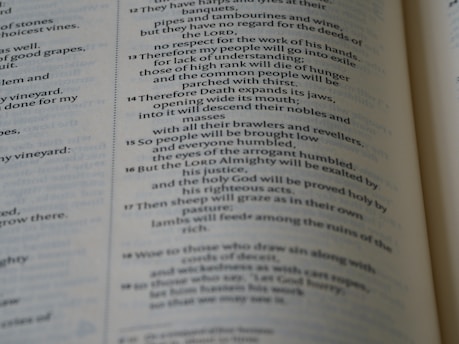 A close-up view of a page from a book, displaying text with a religious or literary context. The text is printed in a serif font, and the page is part of a larger bound volume.