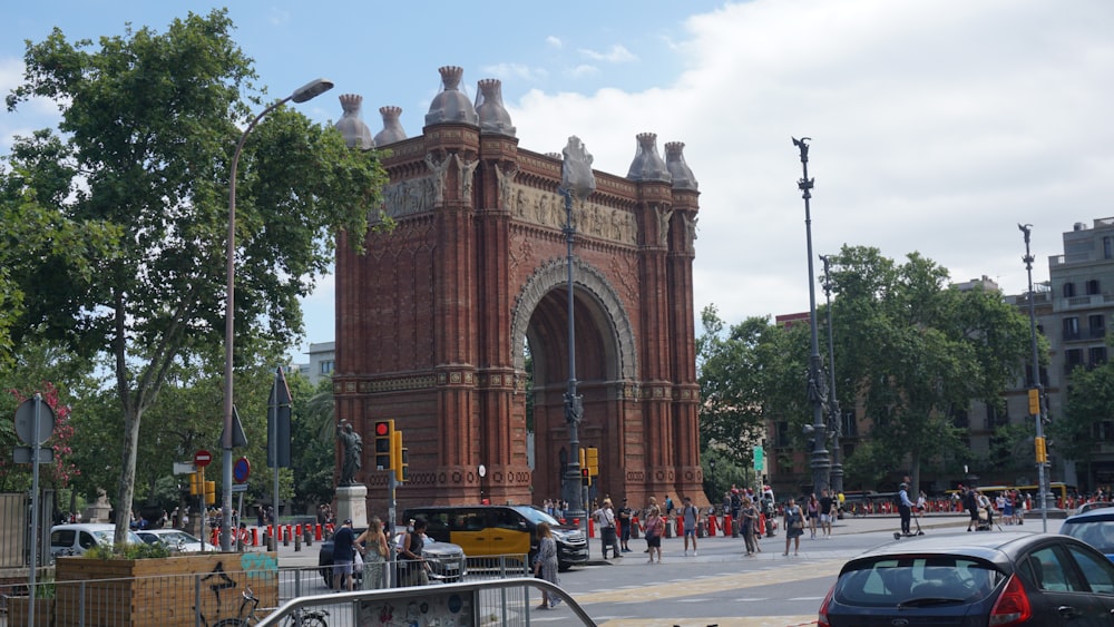 a large brick clock tower sitting on the side of a road