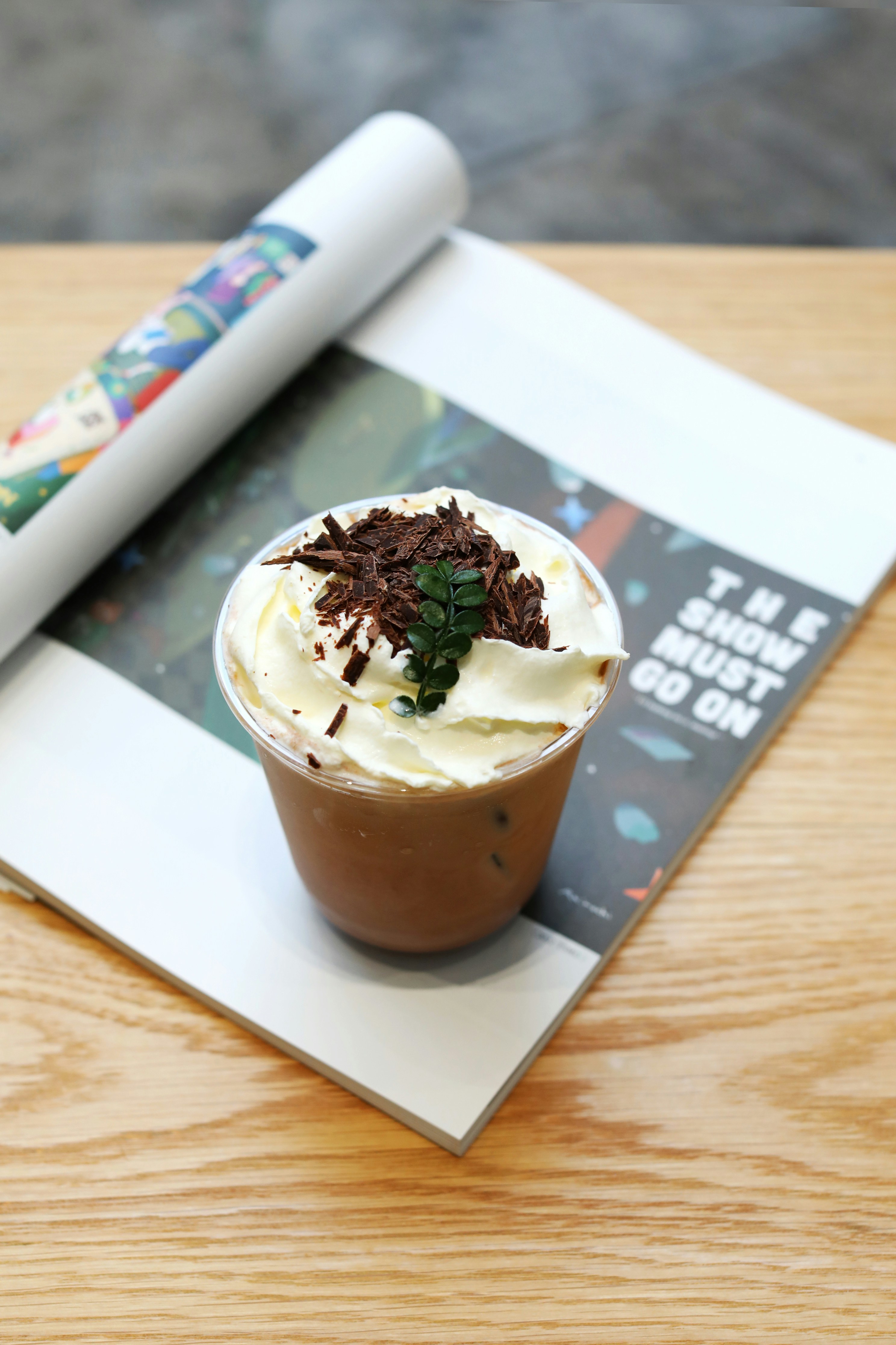 a cup of coffee with whipped cream and chocolate sprinkles