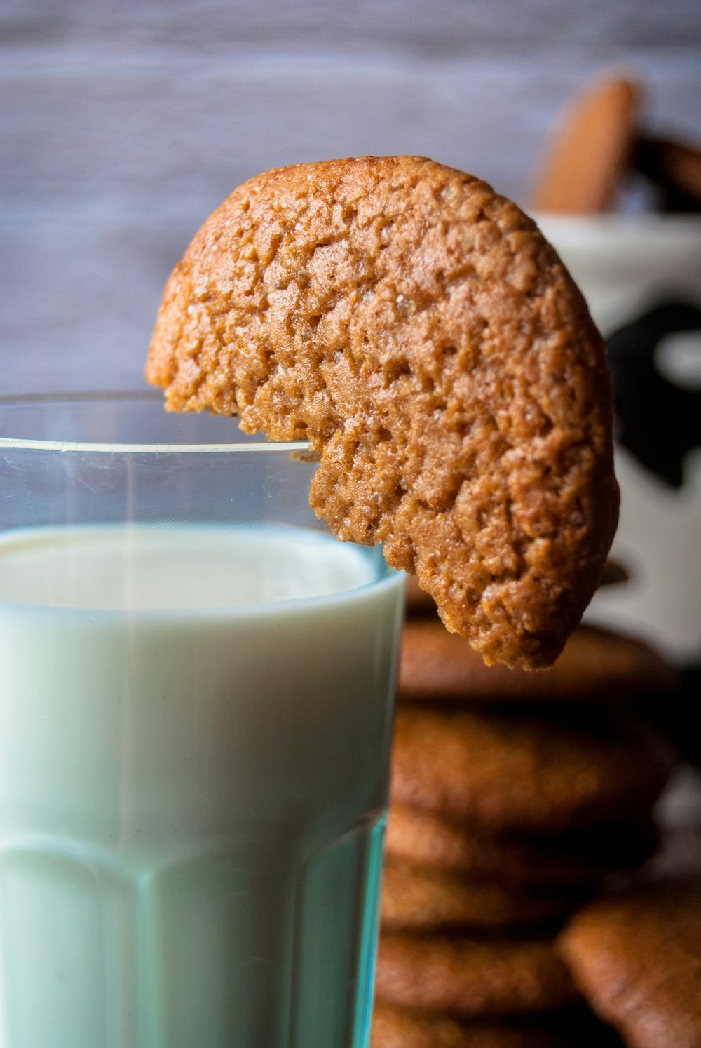 a cookie and a glass of milk on a table