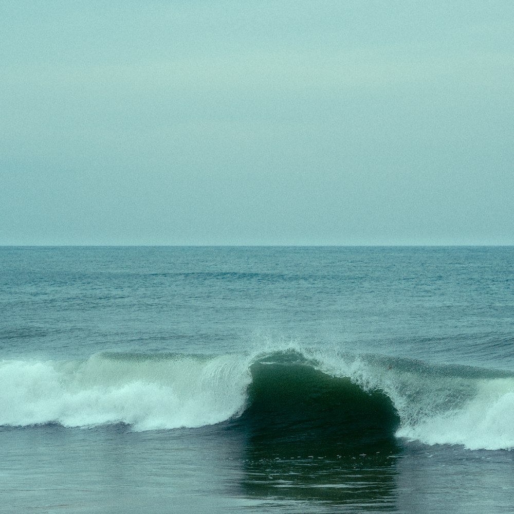 a person riding a surfboard on a wave in the ocean