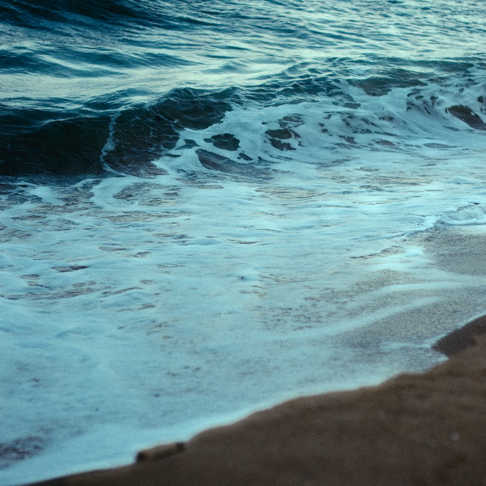 a surfboard sitting on top of a sandy beach