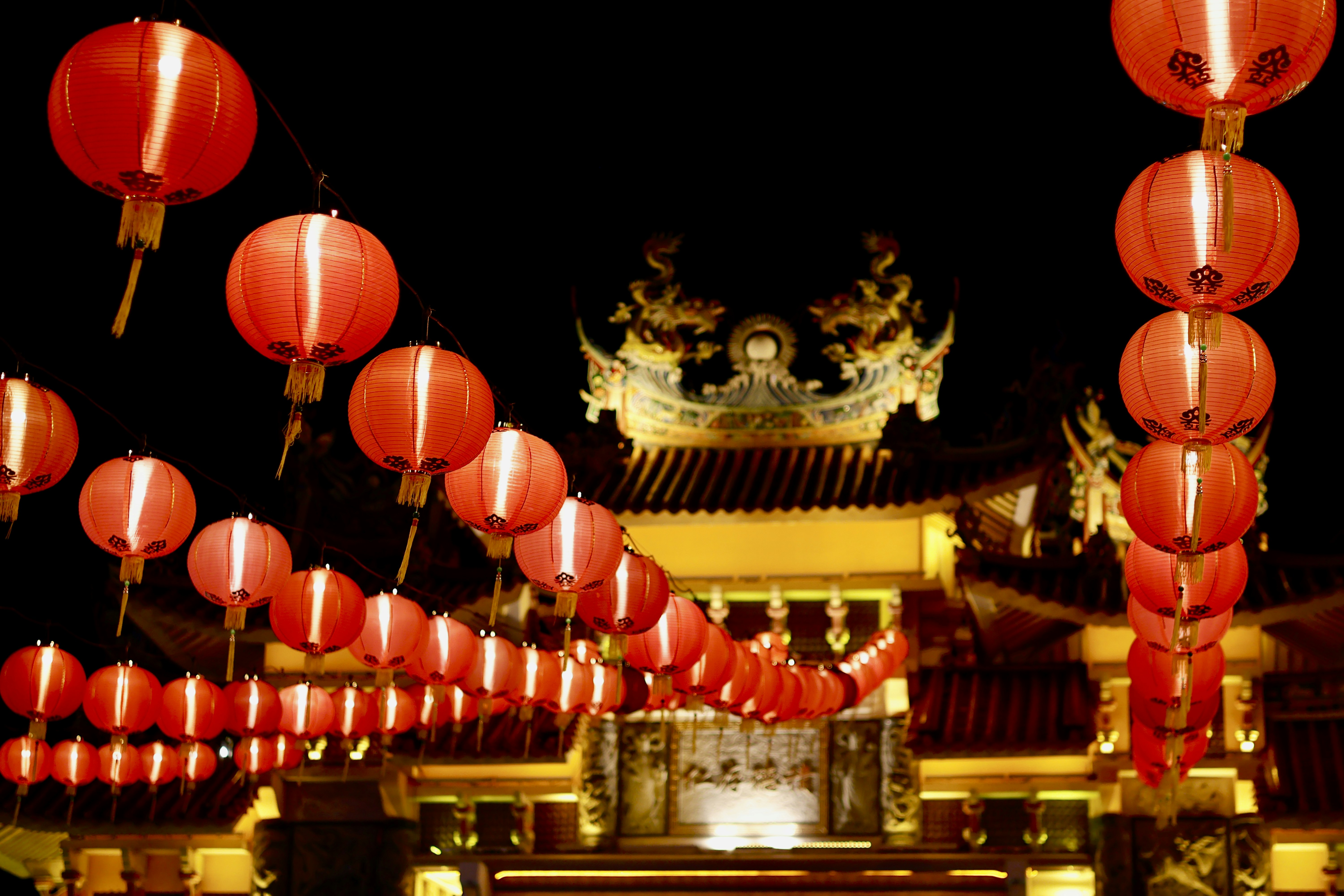 a group of red lanterns hanging from the ceiling