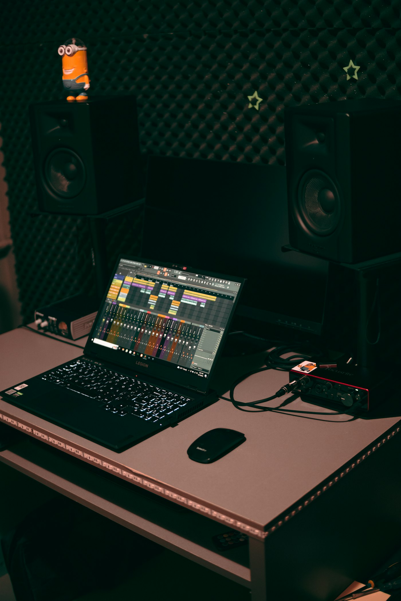 Studio desk with laptop and recording notes