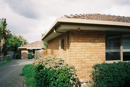 a house with a brick roof and a brick walkway