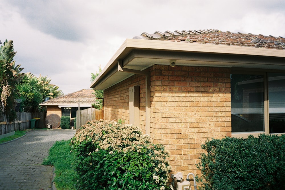 a house with a brick roof and a brick walkway