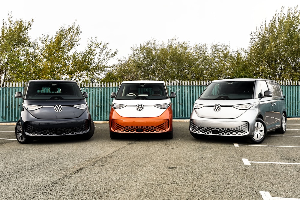 three electric vehicles parked in a parking lot