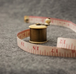 a spool of thread with a measuring tape around it