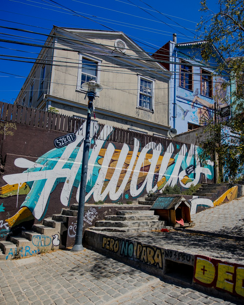 a bunch of graffiti on the side of a building