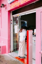 Friendly staff member assisting a customer in the Jinx Dojima shop.