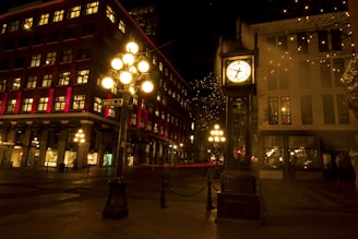 a clock tower in the middle of a city at night