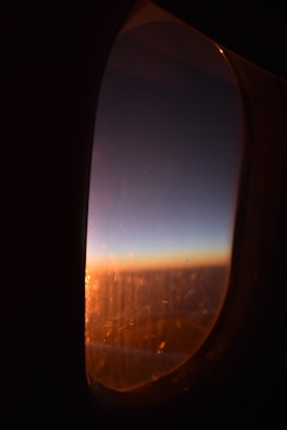 A serene sunset view from an airplane window, inspiring future pilots in training.