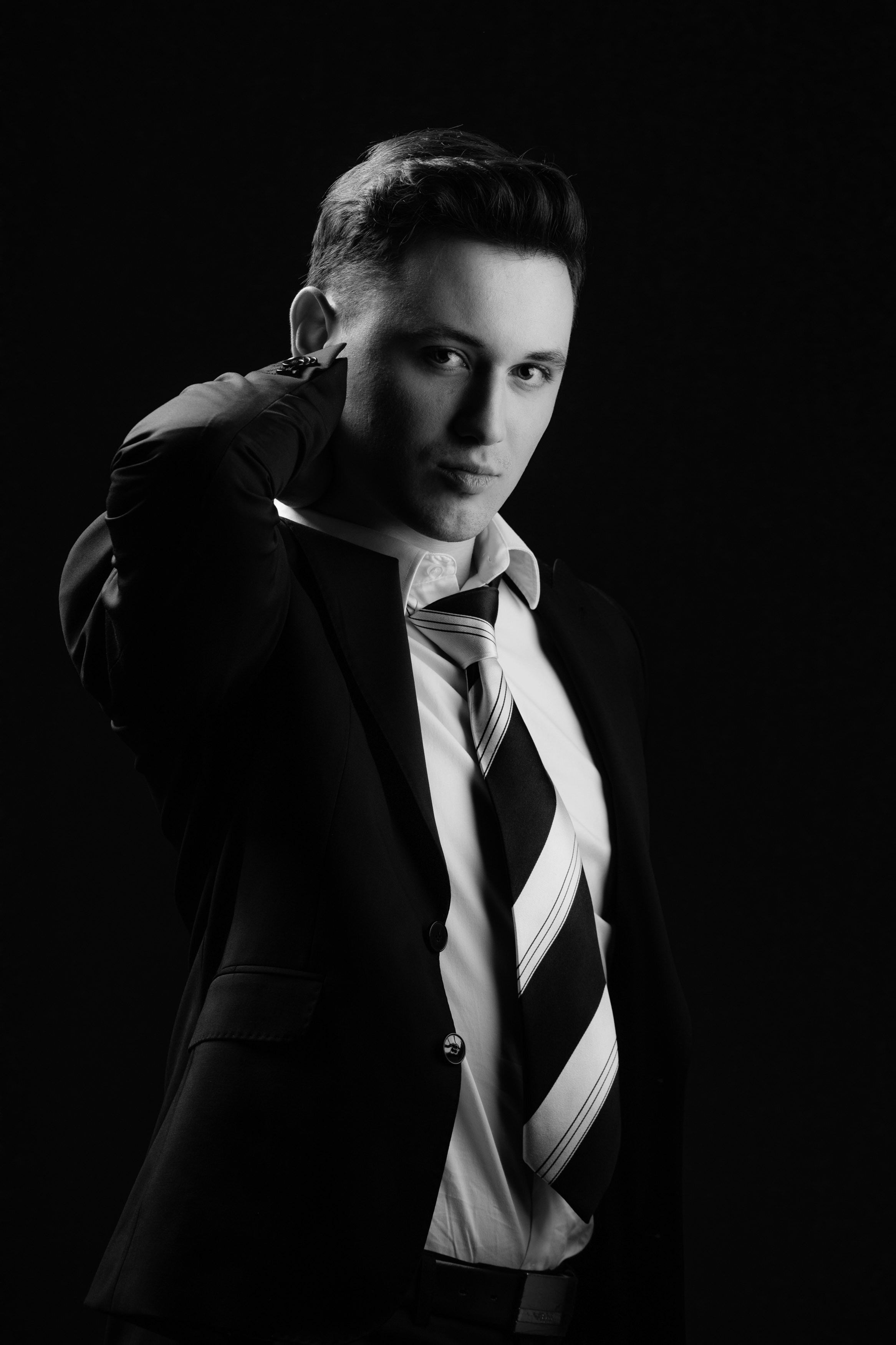 Un hombre con traje y corbata posando para una foto