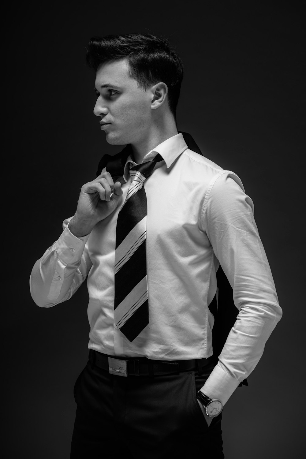 a man in a dress shirt and tie poses for a picture
