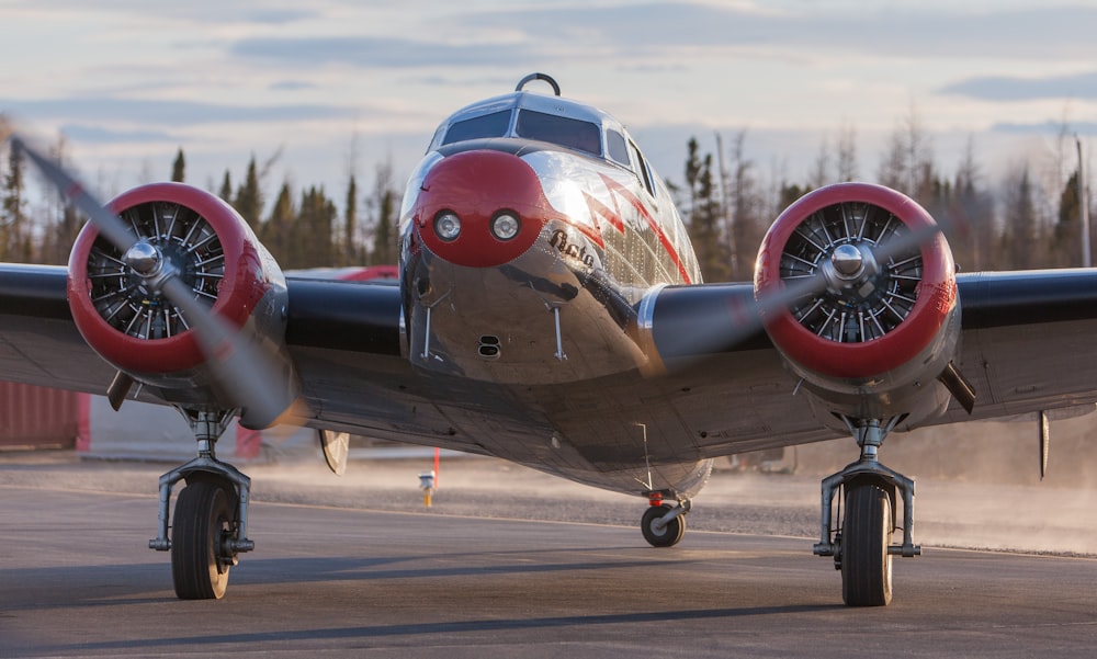 a propeller plane sitting on top of an airport tarmac