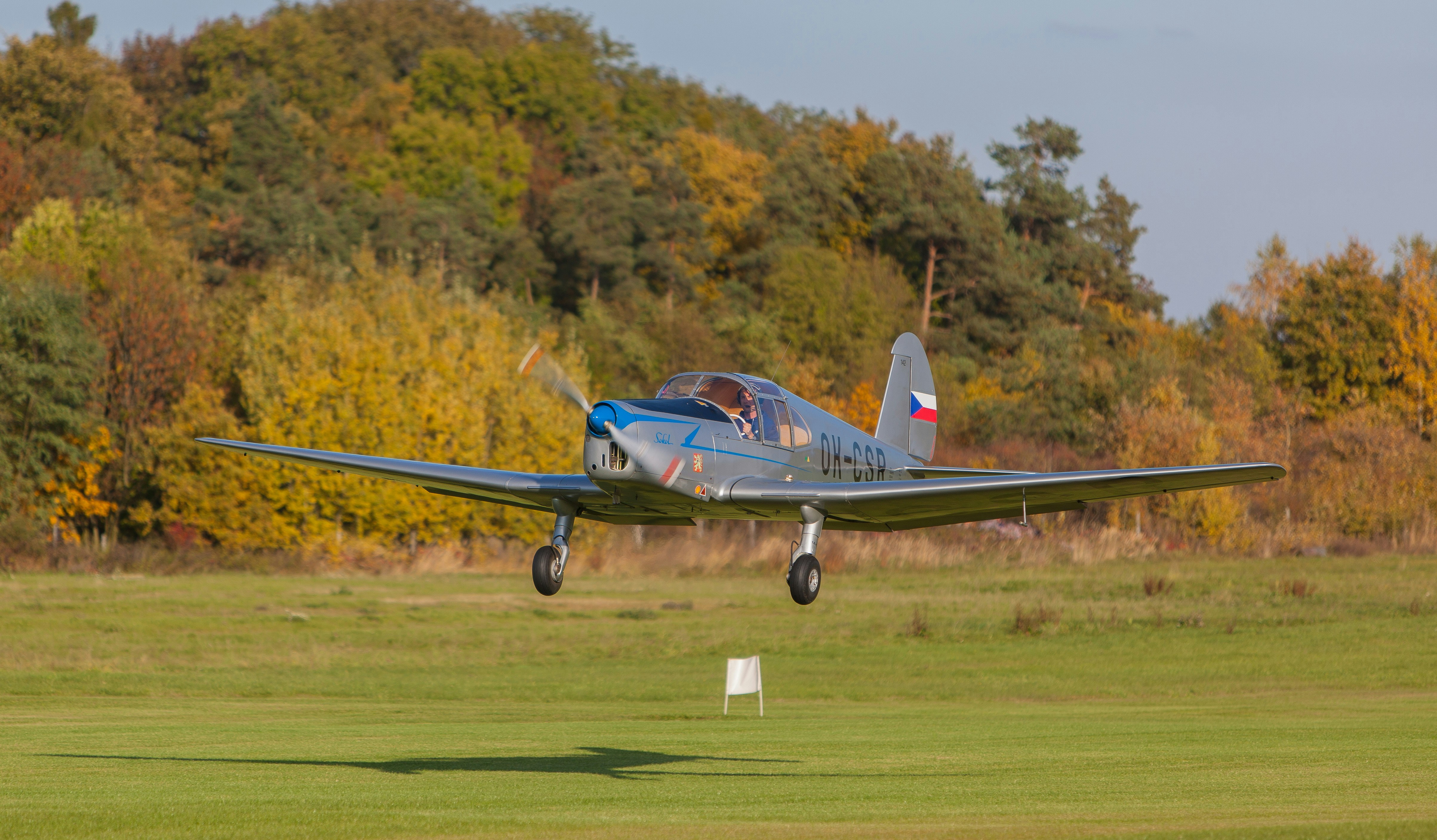 a small airplane is flying low to the ground