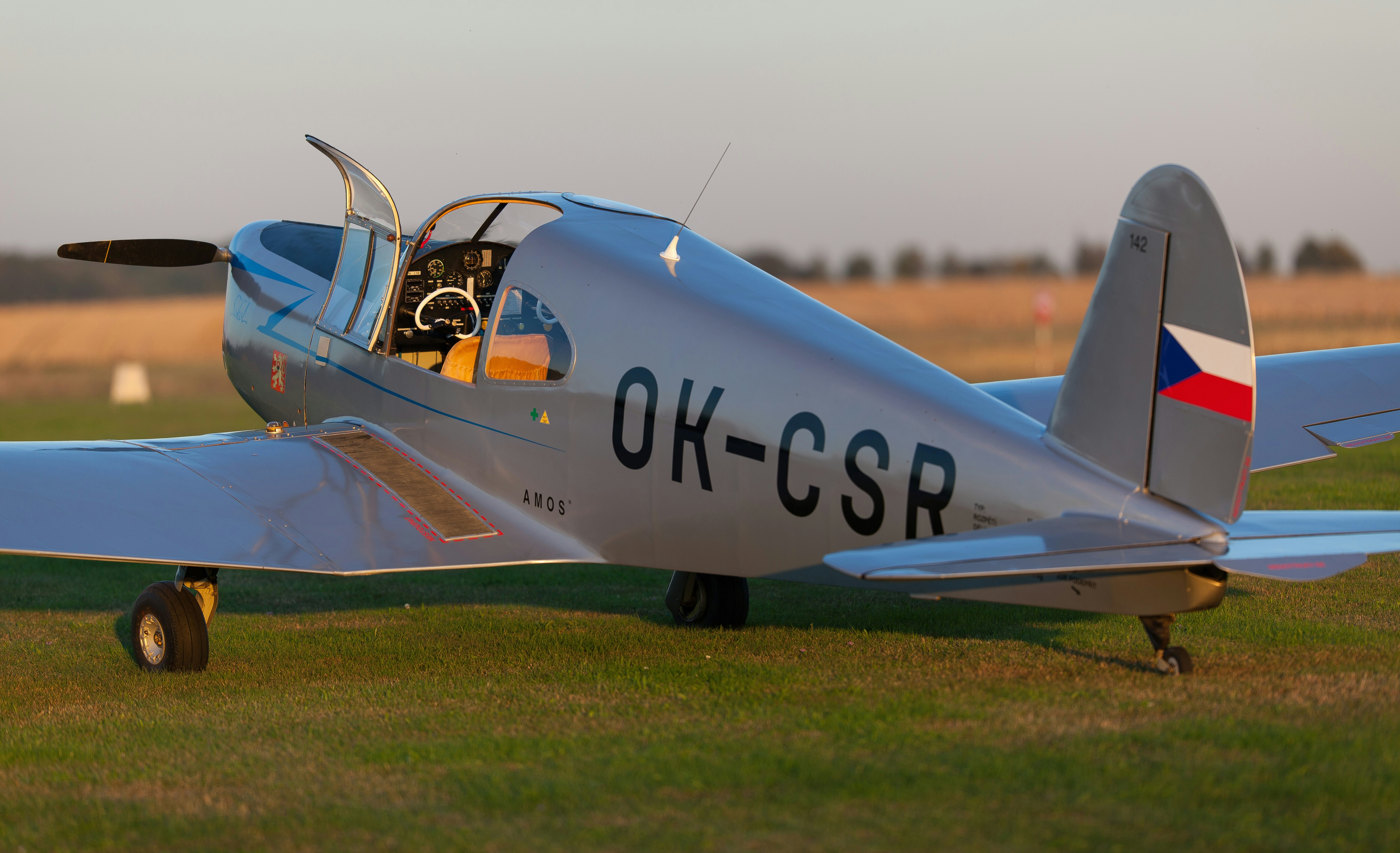 a small airplane sitting on top of a grass covered field