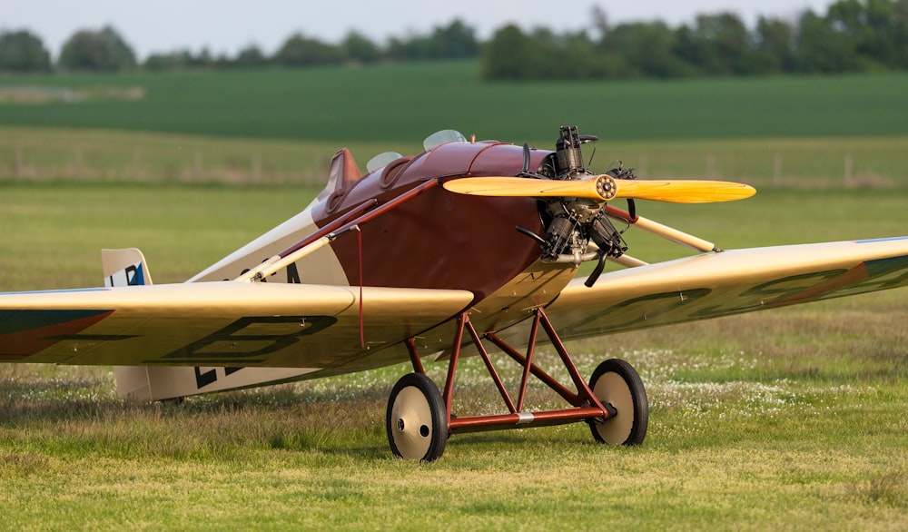 a small airplane sitting on top of a lush green field