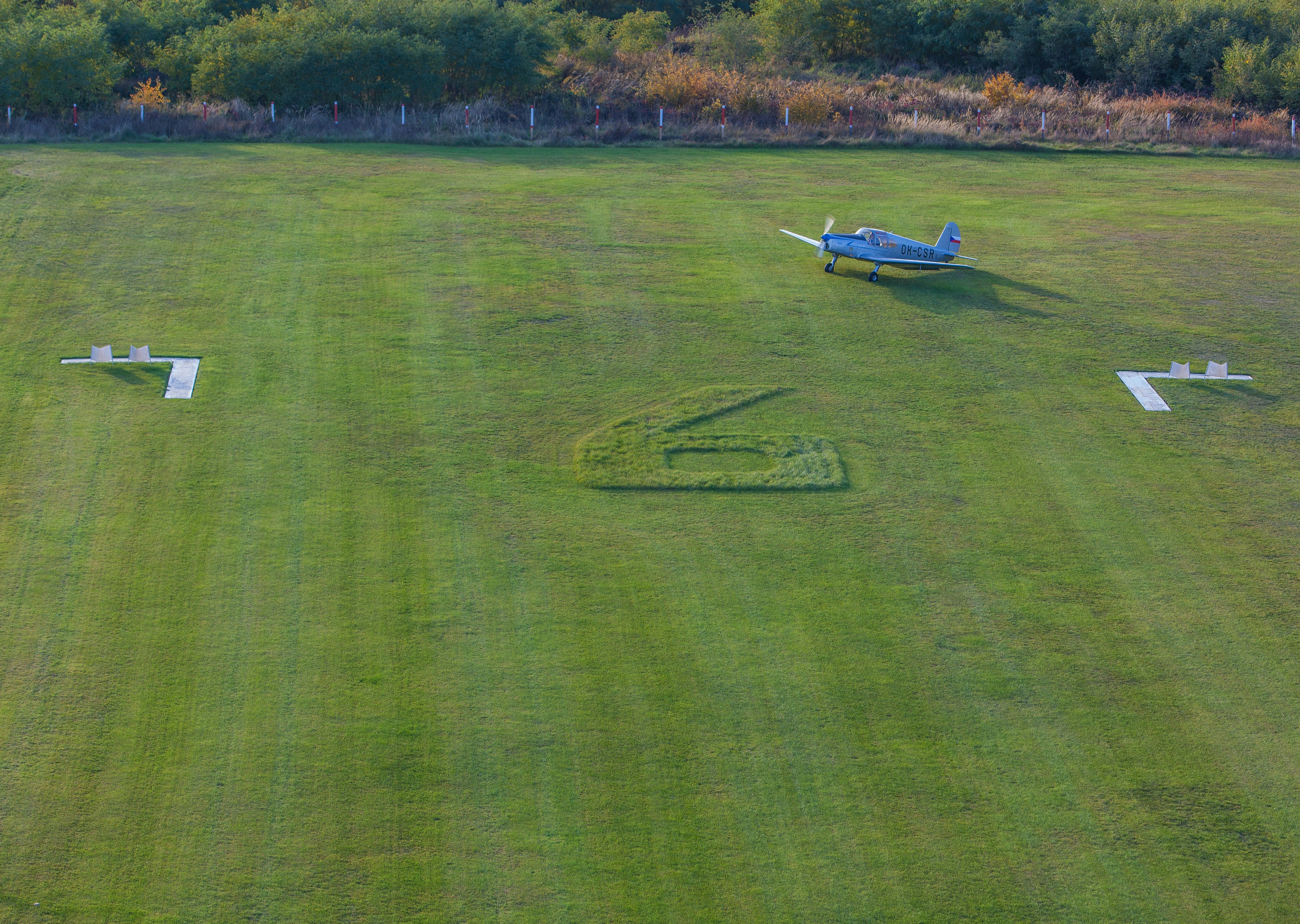 a small plane sitting on top of a lush green field