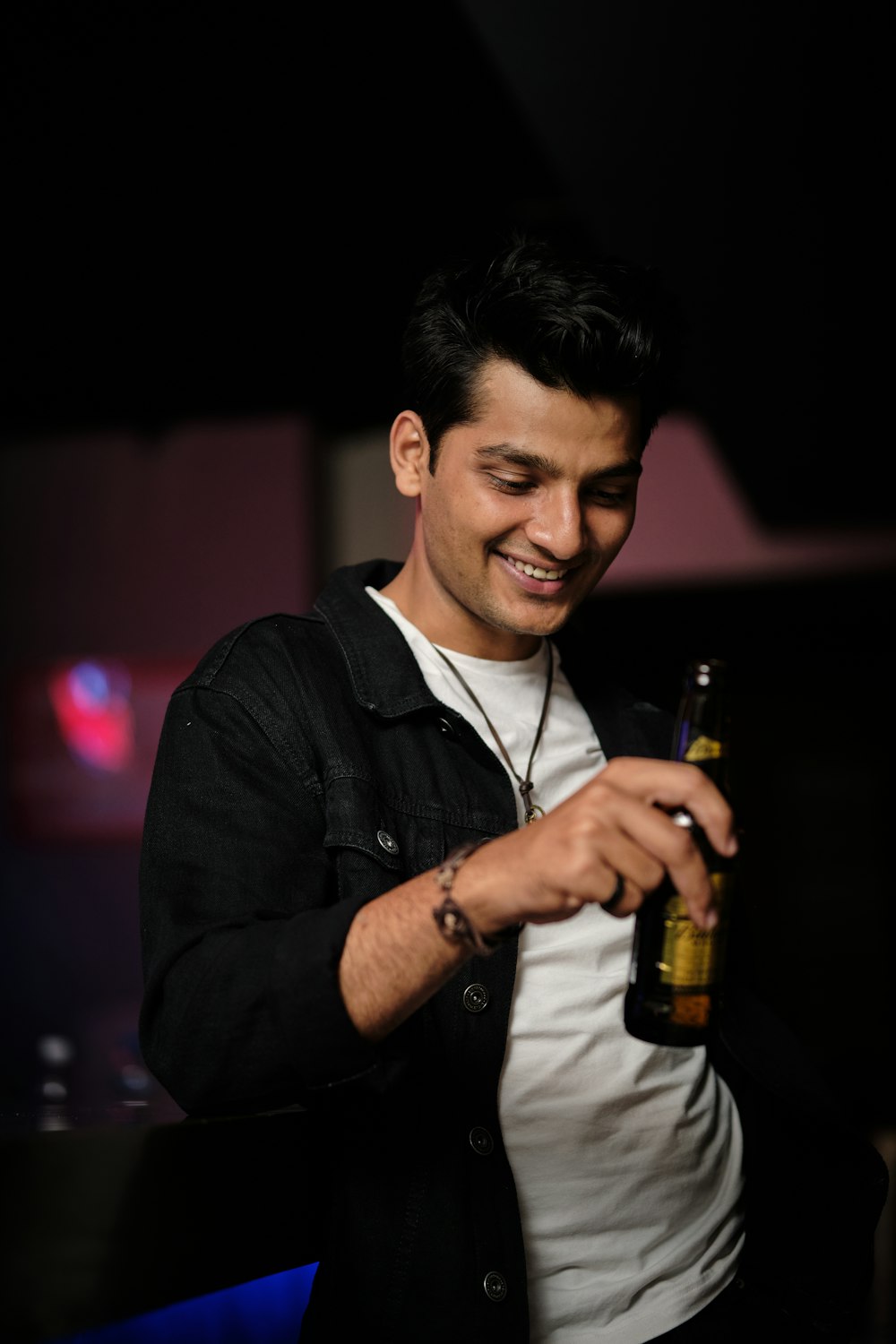 a man holding a bottle of beer in his hand