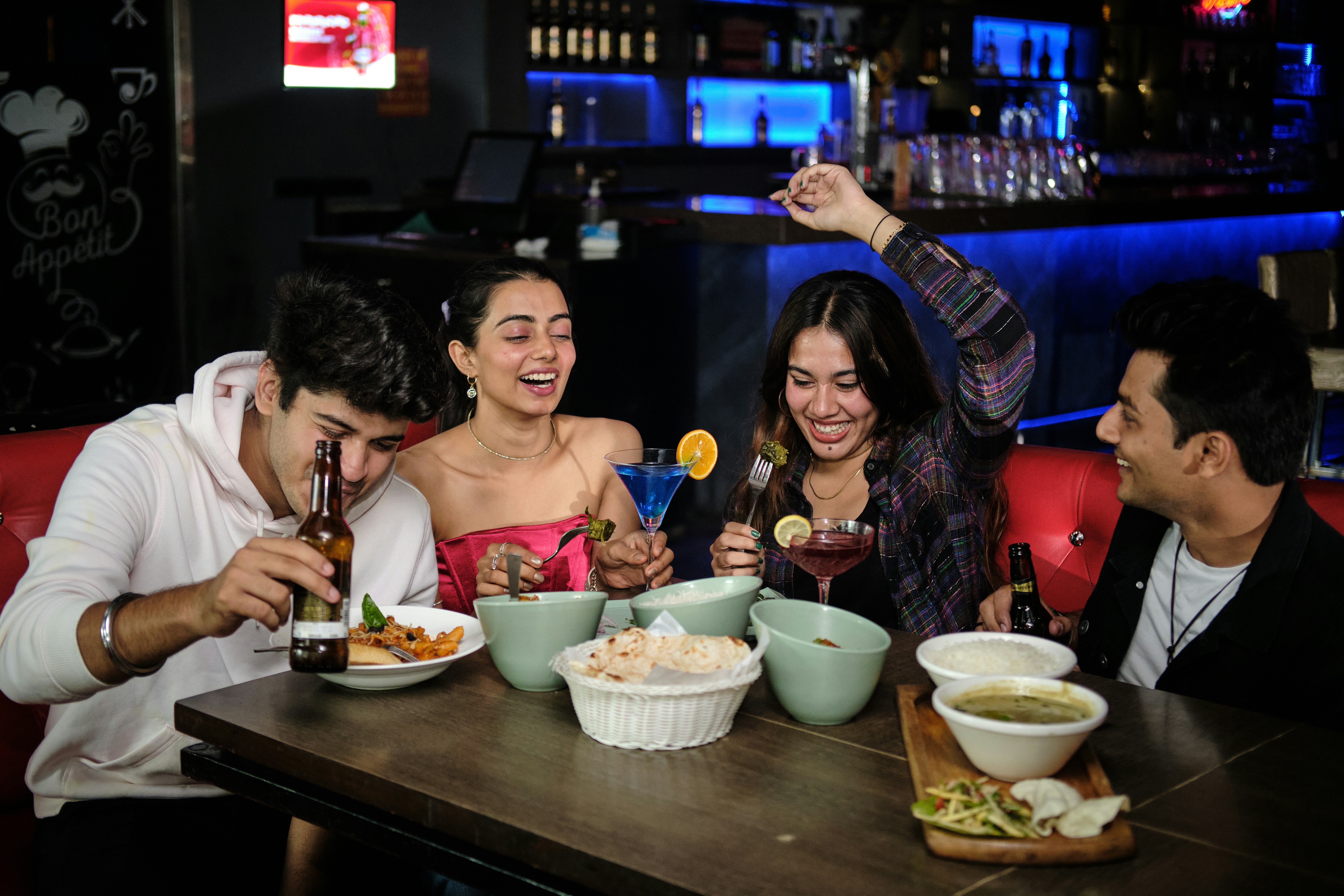 A group of people sitting around a table eating food