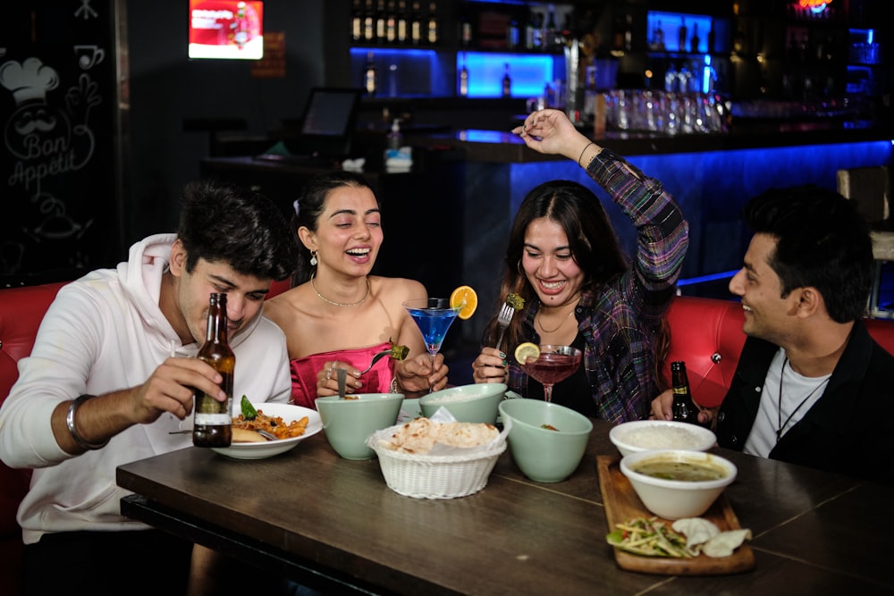 a group of people sitting around a table eating food